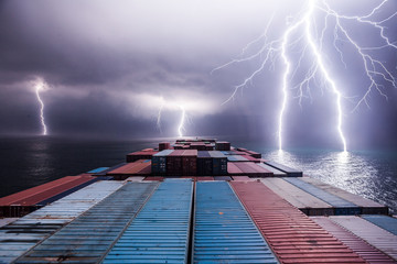 Lightning storm at sea viewed from a container ship