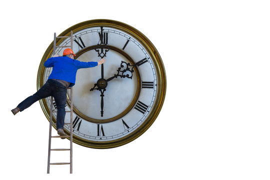 Man is standing on a ladder and adjusting the clock