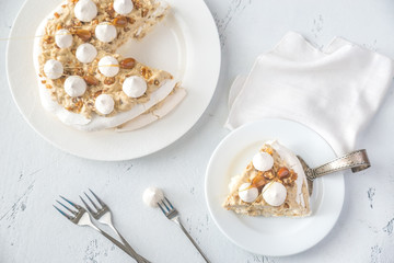 Pavlova cake with caramel and almonds