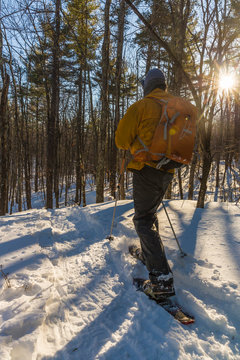 A man snowshoeing on Kennard Hill in Epping, New Hampshire.