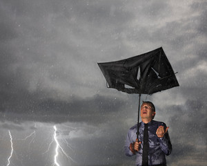 Caucasian businessman caught in a storm