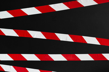 Red and white warning tape on the black background