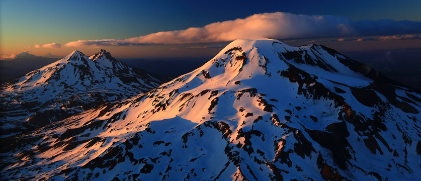 An aeriel view of the Three Sisters with Mount Jefferson and Mount Hood in the distance.