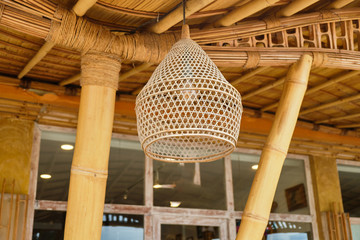 Vintage bamboo lamp on wooden background.