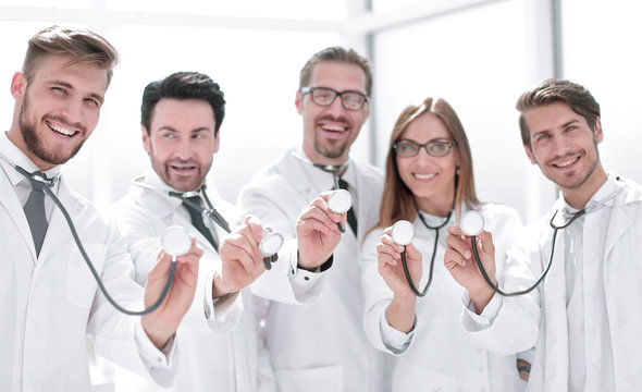 group of doctors hold their stethoscopes