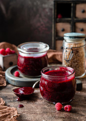 Two glass jars with homemade dark red jam