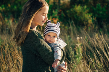 Beautiful mother with a child in her hands