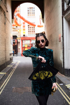 London, young woman with Chinese fan in Chinatown