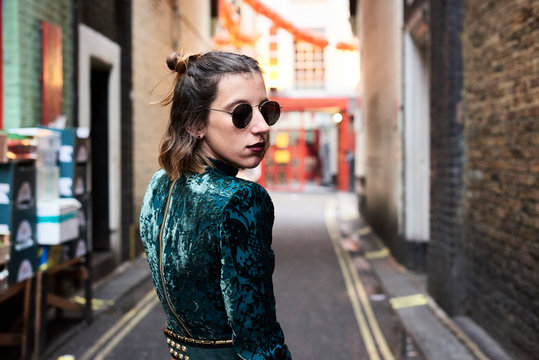 London, young woman walking in Chinatown, turning