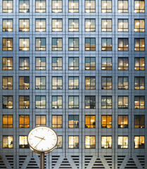 Clock and office windows at dusk