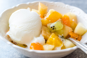 Fruit Salad with Vanilla Ice Cream in Ceramic Bowl.