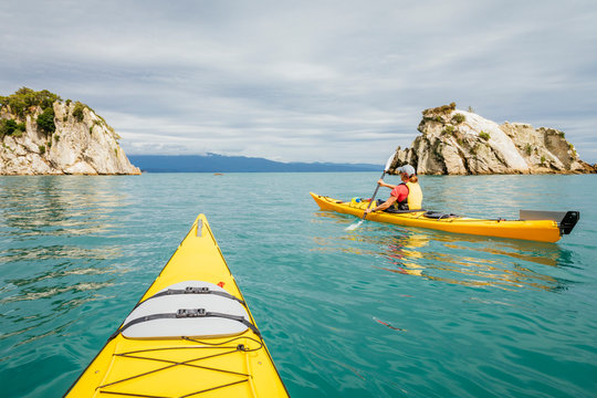 Point of view of person kayaking beside Abel Tasman National Park cliffs
