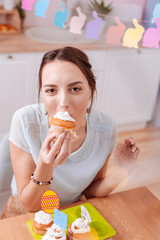 Close up of delighted female that looking at camera