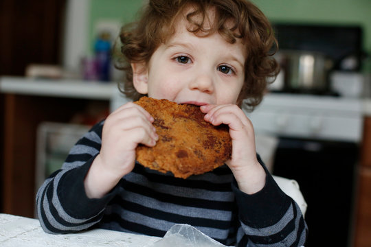 Fototapeta Portrait of boy eating cookie