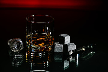 Glasses for whiskey close-up with stones on a glass, isolated on a black background. ice stones,...