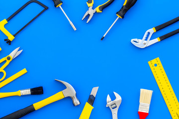 set of tools for constructor work, build, paint and repair house blue background top view copyspace