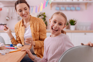 Positive delighted blonde girl posing on camera