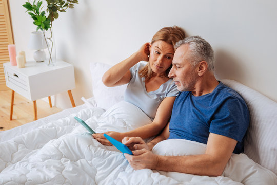 Mature businessmen using their tablets reading working e-mail - Powered by Adobe