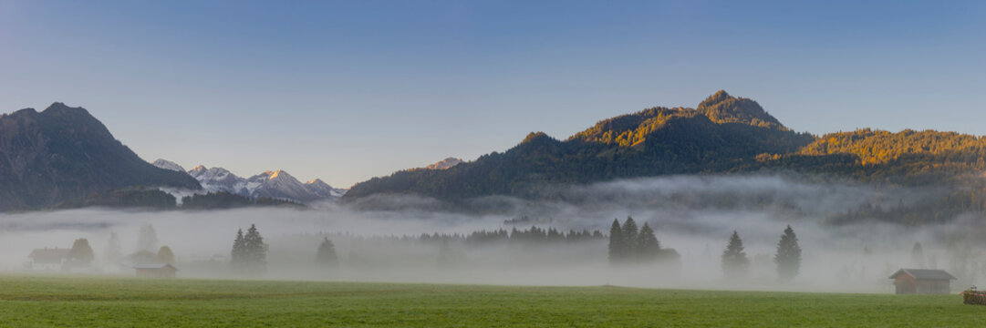 Germany, Bavaria, Upper Allgaeu, Loretto meadows near Oberstdorf with morning fog and mountains in background