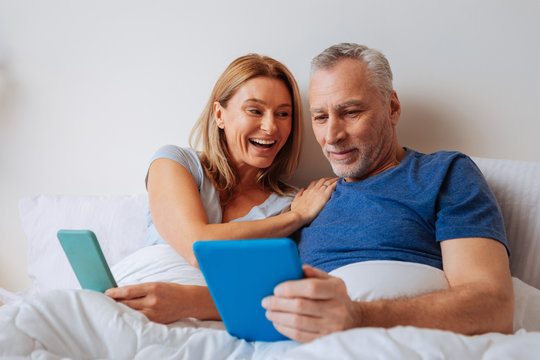 Beaming loving wife asking her husband to buy her new jewelry