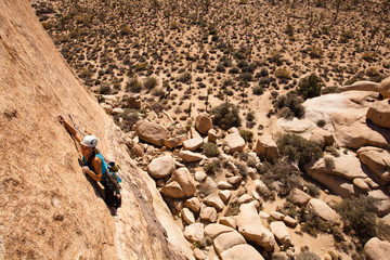 A female climber starts the dike traverse on Sidewinder (5.10b) in Joshua Tree National Park, California on October 24, 2013.