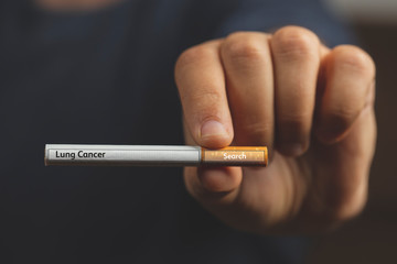 Hand holding a cigarette with search engine tab on it , LUNG CANCER CONCEPT