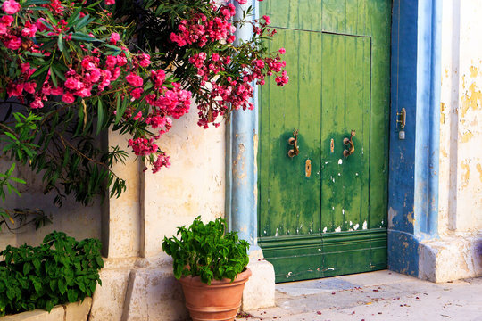 Green doorway with flowers in historic walled city of Mdina, Malta