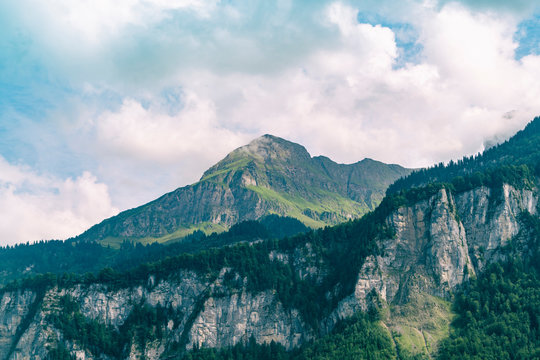 Mountainscape with summit and forest among mist, Central Switzerland, Bern, Switzerland
