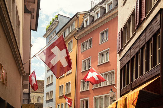 Picturesque old town street with Swiss flags, Zurich, Switzerland