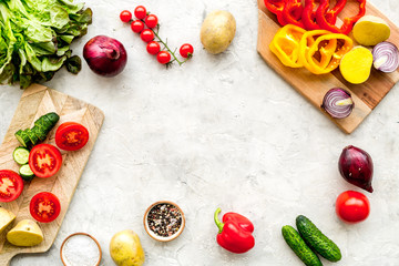 Fresh organic vegetables for healthy food cooking on light stone background top view mock up