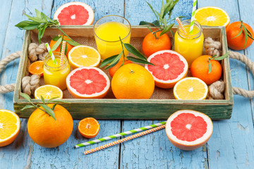 Set of different fruits and glass with fresh orange juice