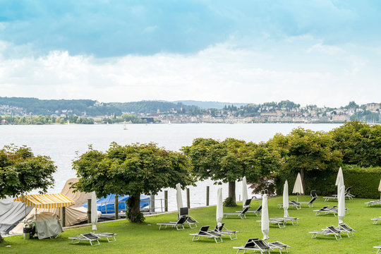 Landscape with Lake Zug, trees and beach chairs, Zug, Switzerland