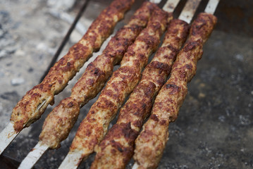 Shish kebab on a metal stick, top view. Lula kebab on skewers 