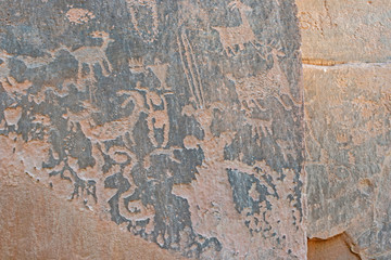 Rock Art scenes carved by the ancients on boulders in Utah.