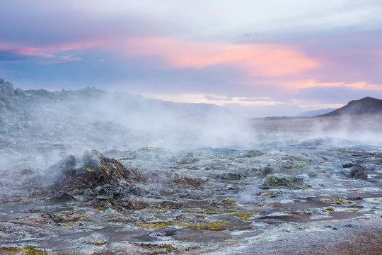 Steaming blue coloured mud pools an orange cloud in the sky, at Hverar ndor Hverir Geothermal Area, at Namaskard Pass in Iceland.