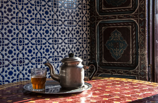 Mint tea in glass and tea pot on table, Marrakesh, Morocco