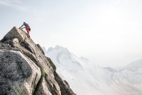 Mountain climber climbing up Bugaboo Spire, Bugaboo Mountains, British Columbia, Canada