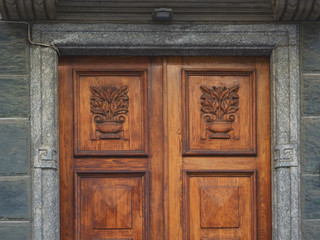 Milan - Italy, carved wooden front door of the 19th century