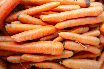 Close up dense lots of yellow carrots in vegetable market