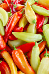 Whole fresh yellow and red peppers background in the market
