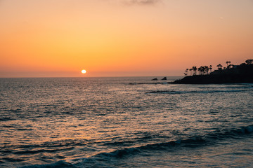 Fototapeta na wymiar Sunset over the Pacific Ocean in Laguna Beach, Orange County, California