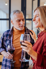Husband and wife drinking wine at home in the evening