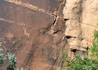 Rock Art scenes carved by the ancients on boulders in Utah.