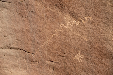 Rock Art scenes carved by the ancients on boulders in Utah.