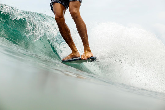 Low section view of surfing man