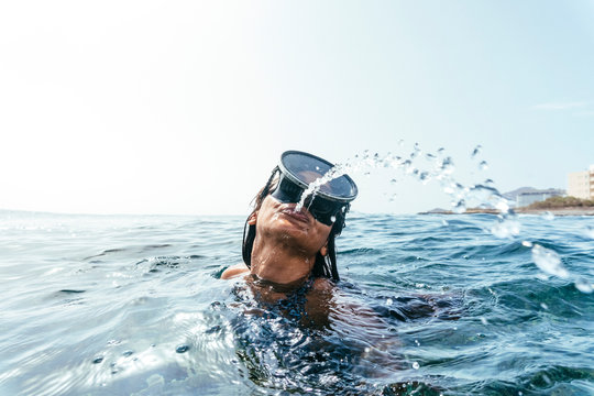 Woman In Diving Goggles Spitting Out Water, Tenerife, Canary Islands, Spain