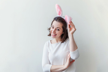 Happy Easter holiday celebration spring concept. Young woman wearing bunny ears isolated on white background. Preparation for holiday. Girl looking happy and excited, having fun on Easter day