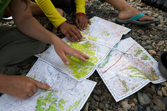 Two women check the maps to plan logistics as they navigate the Onon river in northern Mongolia.