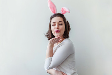 Happy Easter holiday celebration spring concept. Young woman wearing bunny ears isolated on white background. Preparation for holiday. Girl looking happy and excited, having fun on Easter day