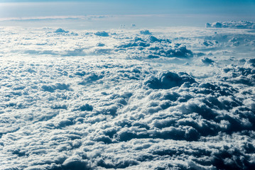 Top view of white clouds above the ground or water